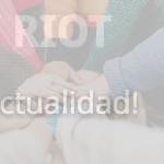 person in red sweater holding babys hand