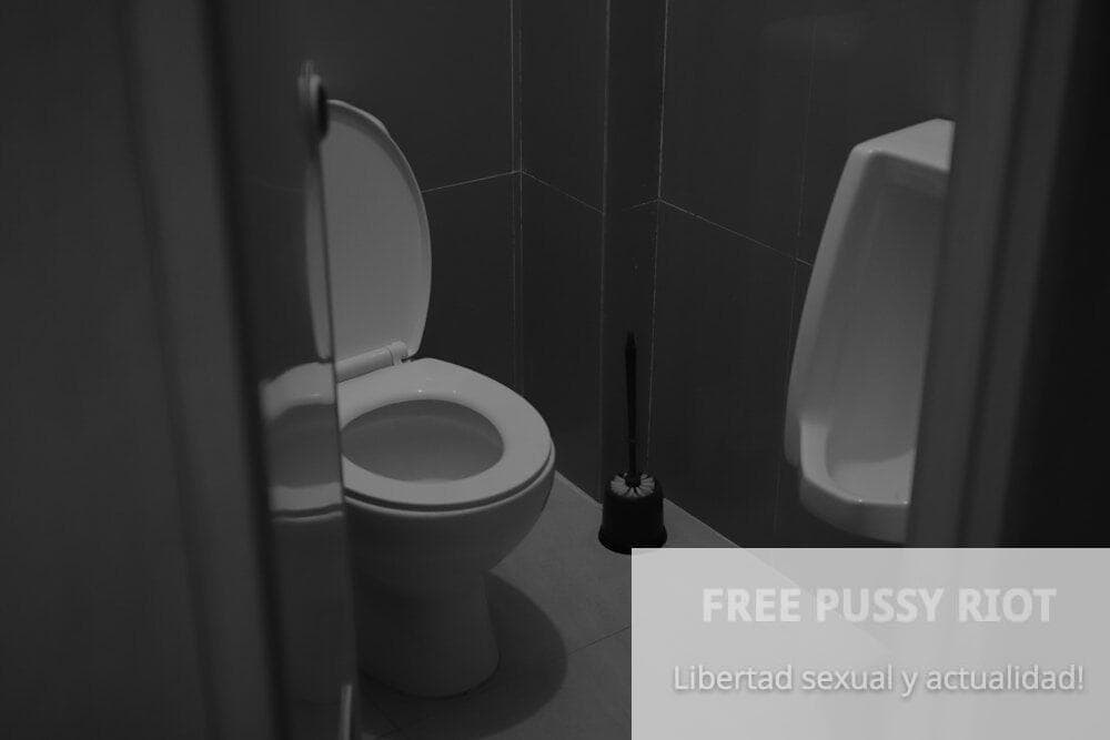 A white toilet sitting next to a urinal in a bathroom